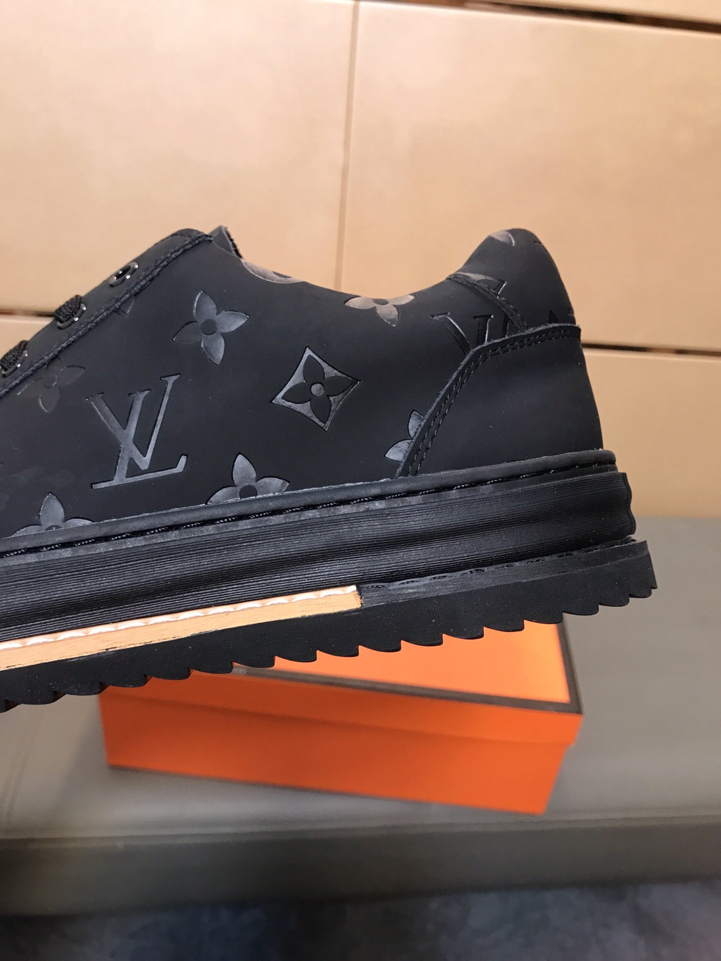 LV TRAINER IN EMBOSSED BLACK SUEDE
